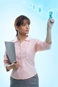 Confident young businesswoman using hi-tech computer monitor 