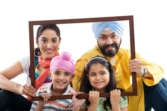 Portrait of a Sikh family through a wooden frame 