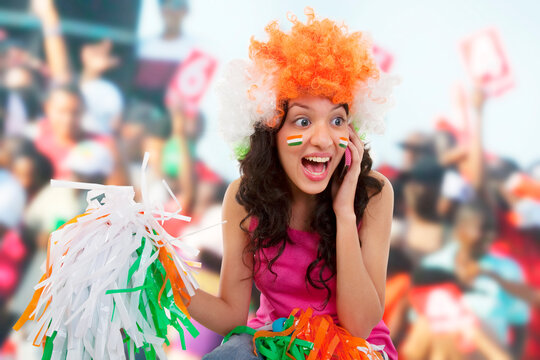 Girl talking on a phone and cheering 