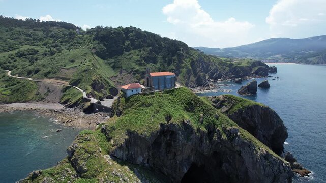 Aerial view of San Telmo Hermitage perched on the cliffside overlooking the Atlantic Ocean in Zumaia, Basque Country, Spain.