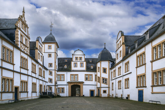 Inner courtyard of Neuhaus Castle in Paderborn, Germany, opposite view. Traditional palace architecture under cloudy winter sky