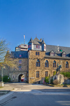 Burg Castle in Germany, entrance arch and monument view. Medieval fortress architecture under clear blue sky without snow