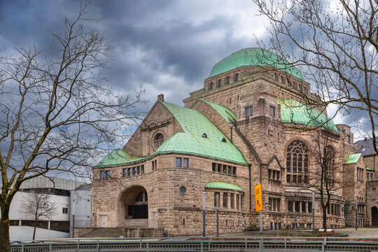 Old Synagogue in Essen, Germany, three quarter view. Historic art nouveau and Byzantine style architecture under cloudy winter sky.