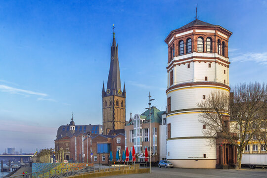 Dusseldorf historic center with Old Castle Tower and St Lambertus Church, Germany, cityscape view. Historic architecture under clear blue sky