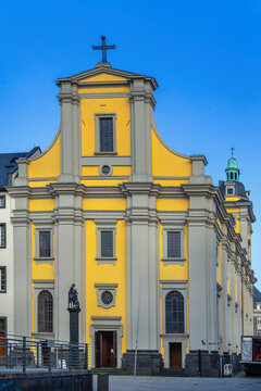 St Andreas Church in Dusseldorf, Germany, front view. Historic baroque church architecture under clear blue sky without snow