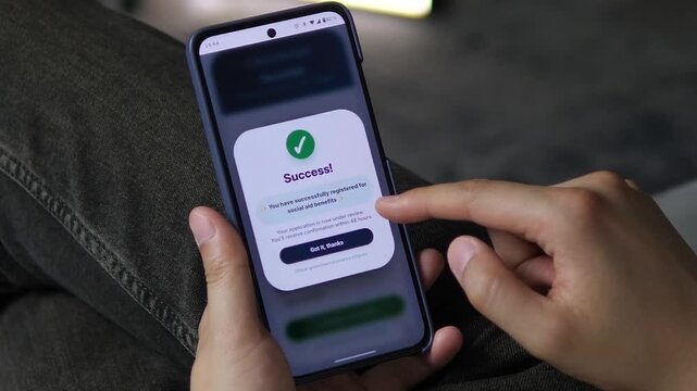 Smartphone user completes an online benefits form and receives confirmation, reflecting the shift toward faster digital welfare services and remote applications.