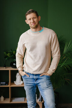 Man Standing in Room Wearing Casual Sweatshirt