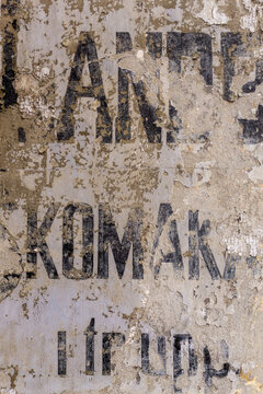 Weathered wall with peeling paint and distressed typography
