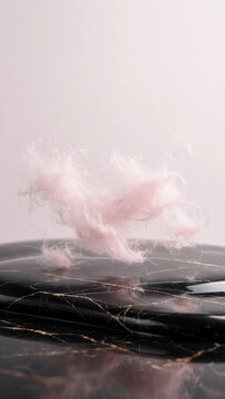Vertical Pastel Pink Spun Sugar Fibers Floating Over Glossy Black Marble 3D Render
