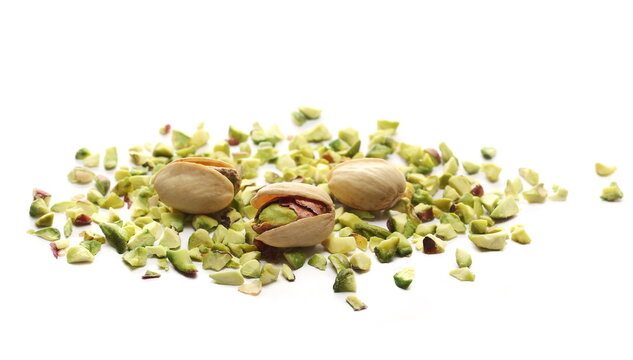 Pistachios chopped pile with nutshell isolated on white background, side view