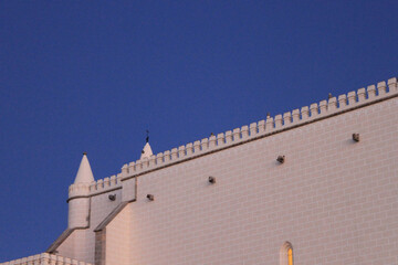 Roofline and Battlements of Saint Francis Church at Blue Hour Twilight in Evora Portugal, Manueline Gothic Architecture Details in UNESCO Historic City © monkeybusiness.pt
