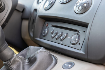 Automobile dashboard radio control panel and manual gear stick in a vehicle interior, capturing a functional and utilitarian automotive design for transport or travel service themes © Alina