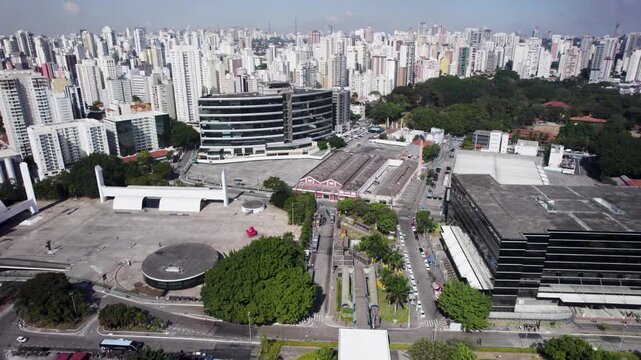 Travelling drone for the left showing te Memorial of America Latina infirst plan and S&atilde;o Paulo&acute;s Skyline with a lot of buildings in the background