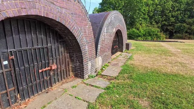 Restored brick pyrites kilns on Spike Island nature park in Widnes closeup right dolly shot