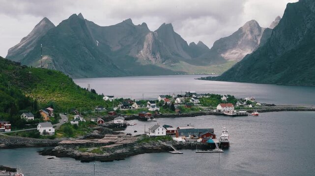 Mountain light falls across a coastal village in the Lofoten Islands, Norway