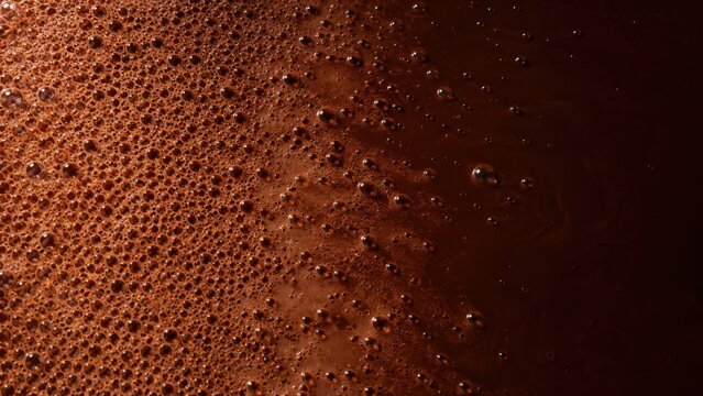 Coffee Foam with Bubbles on Dark Liquid Surface