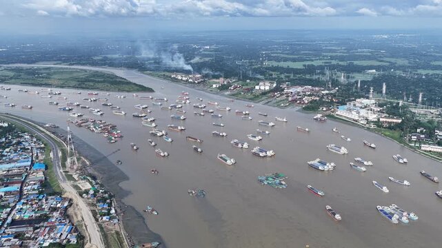 Aerial view of the Karnaphuli River filled with numerous cargo ships and barges near the Karnaphuli 3rd Bridge in Chittagong, Chittagong Division, Bangladesh.