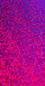 Rotating Iridescent Sequin Texture. Macro view of reflective sequins rotates under shifting multicolor light, creating vivid color changes.