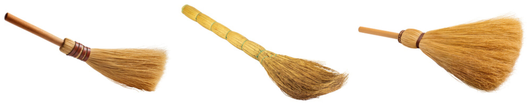 Three brooms with wooden handles and natural bristles, isolated on a white background