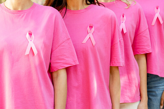 Women wearing pink ribbons for breast cancer awareness