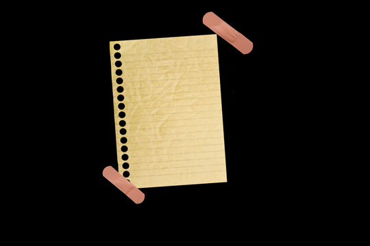 Piece of notebook paper patched with a torn bandage, isolated black JPEG.