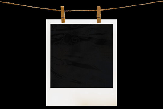 Blank photo frame hanging on a rope with a wooden clothespin. Isolated black JPEG mockup.