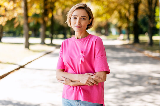Woman wearing pink ribbon for breast cancer awareness