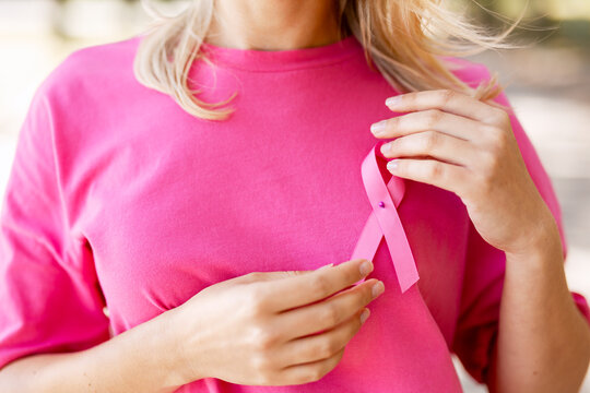 Woman wearing pink ribbon for breast cancer awareness