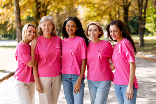 Diverse women supporting breast cancer awareness outdoors