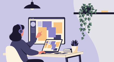 Fototapeta premium Person working on computer at home office desk with hanging plant