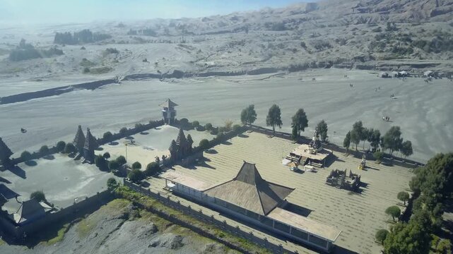 Aerial view of Pura Luhur Poten temple situated on the vast volcanic sand plain of Mount Bromo in Kecamatan Sukapura, Jawa Timur, Indonesia.