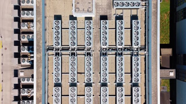 Aerial view of the STACK Infrastructure GEN02A Data Center rooftop featuring rows of industrial cooling fans in Gland, Vaud, Switzerland.