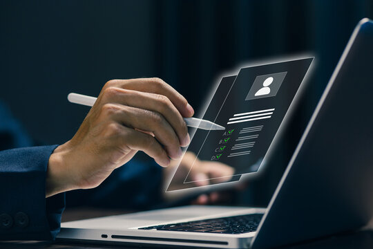 Business professional completes digital application form on laptop using stylus, illustrating online registration, document verification, recruitment, data entry, and paperless workflow.