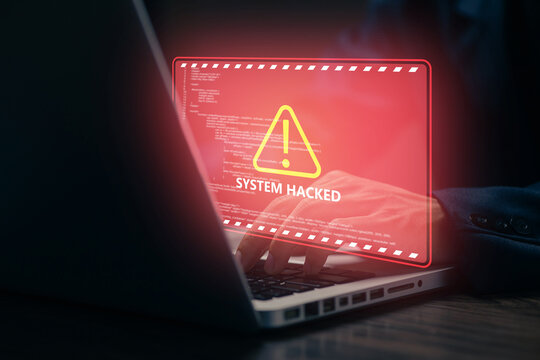 System hacked warning appears on laptop screen as cyberattack threatens digital data, illustrating cybersecurity breach, malware, hacking, online danger, and network security risks.
