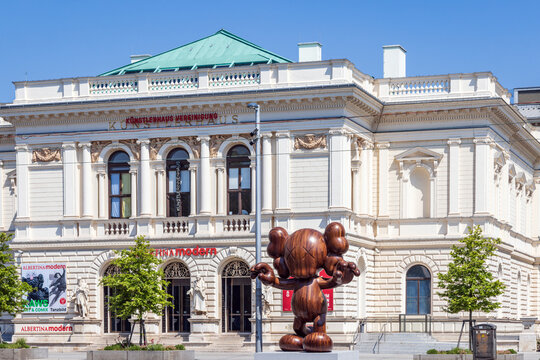 The Albertina modern art museum in the historic K&uuml;nstlerhaus in Vienna, Austria. The wooden figure in front of the building is FINAL DAYS by artist KAWS