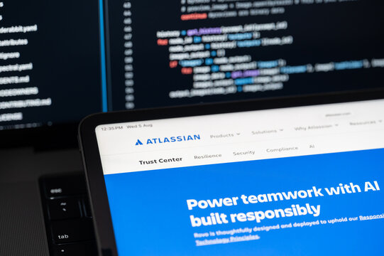 Atlassian Ai company web page on program code background