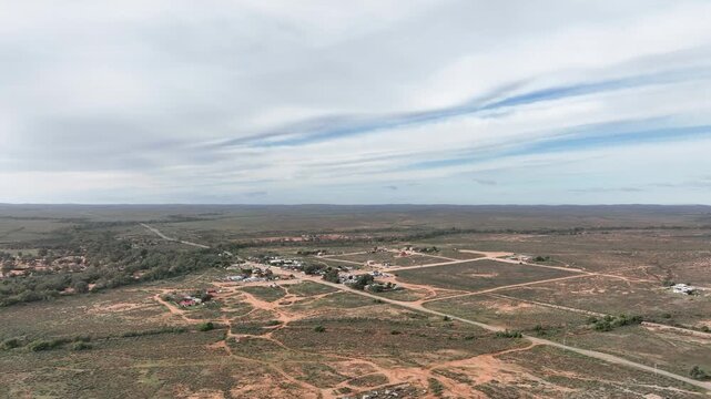 Expansive aerial drone view over the historic outback settlement of Silverton surrounded by vast semi-arid wilderness near Broken Hill, New South Wales.