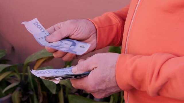 closeup male hands hold Moroccan dirham money, count paper dirham banknotes, concept cash payments, monetary savings, save for vacation, exchange and cashing currency