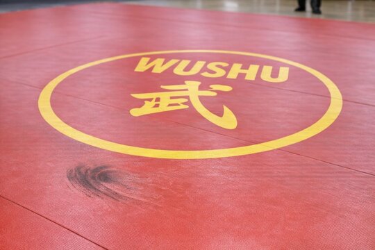 A close-up shot of a wushu mat with the words 'wushu' written on it