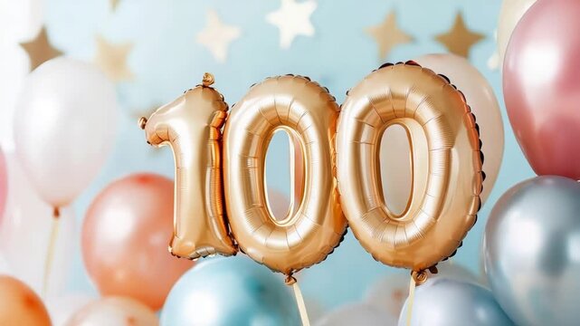 Golden 100 balloon celebration with colorful balloons and stars on blue background