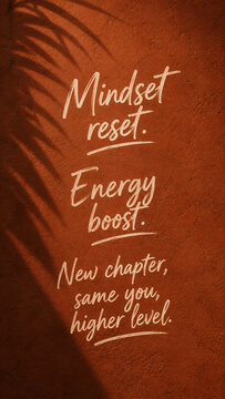 Mindset Reset Energy Boost Motivational Quote Hand Lettered on Terracotta Wall with Palm Shadow