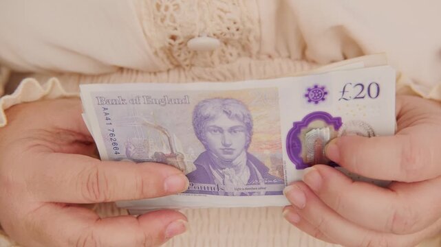 Close-up female hands counting uk pounds bills, paper money, British GBP banknotes, Bank of England currency, Money Management Accuracy, salary, payments fund, financial freedom, save up for vacation
