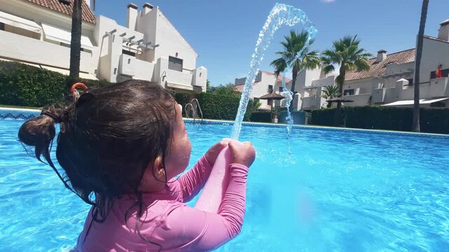 Young Girl Developing Water Skills While Playing with a Pool Noodle