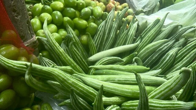 Fresh Green Snake Gourds Trichosanthes cucumerina Arranged Together as Tropical Vegetable Market Produce