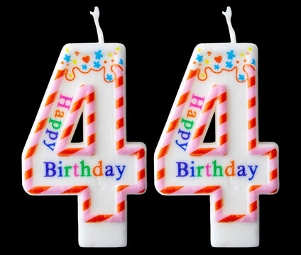 Number forty four shaped birthday candle with colorful sprinkles and Happy Birthday text isolated on a black background
