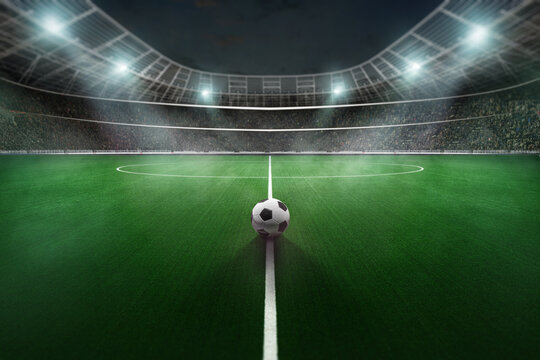 Soccer ball on the big textured soccer game field, stadium. Ready for game in the midfield