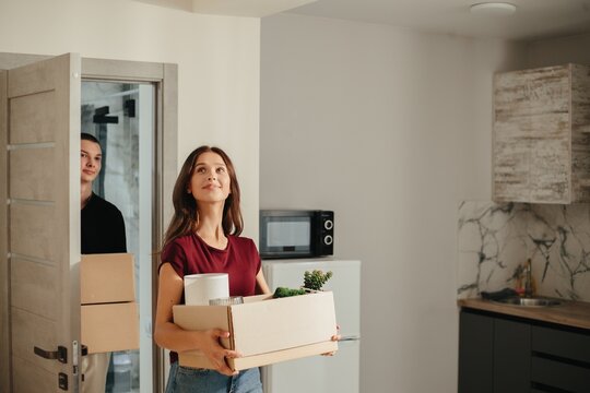 Young couple moving into new apartment looking happy