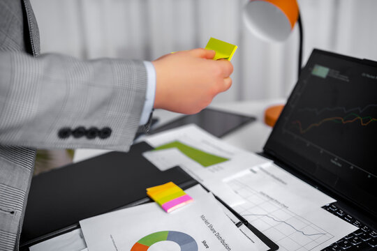 Business woman analyzing financial stock market charts working on laptop in office corporate accountant business analyst financial director. Stress deadline overload planning and budgeting concept.