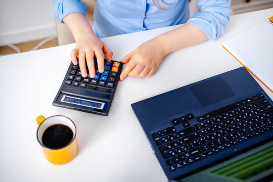 Business woman calculating tax audit and budget using calculator and laptop in office corporate accountant financial analyst auditor. Desk workplace process of calculating financial report concept.