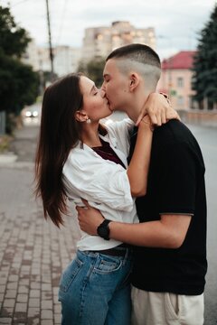 Young couple kissing embracing love on street
